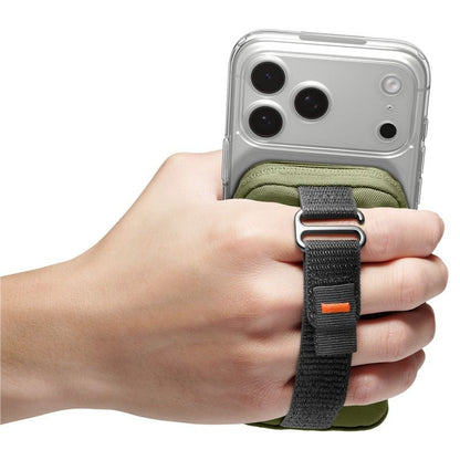 A hand holding a silver smartphone with a green and black phone strap accessory wrapped around the wrist, shown against a plain white background.